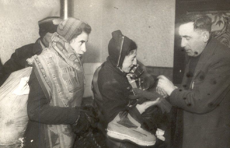 A Judenrat clerk in the Lodz ghetto with women scheduled for deportation from the ghetto.